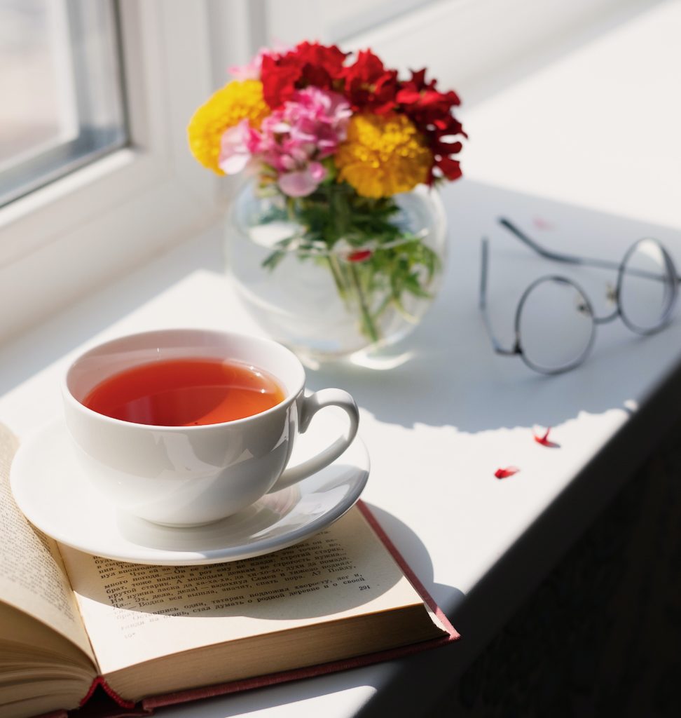 cup of tea with book and glasses