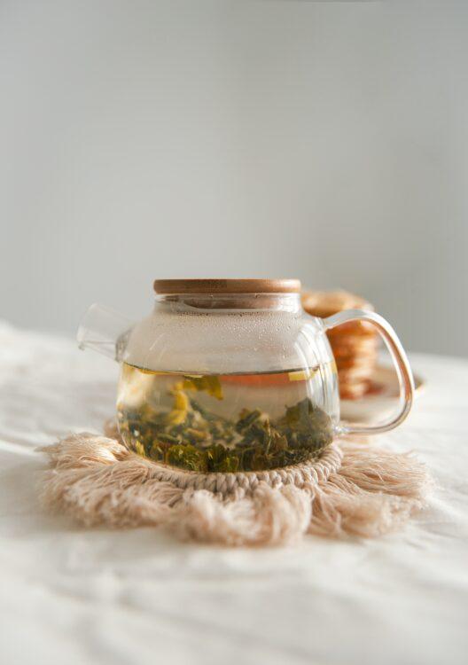 A glass pot of green tea, which is one of the best teas for acne