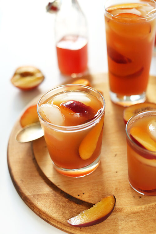 Two glasses of peach iced tea, which is one of the best non-alcoholic drinks for summer