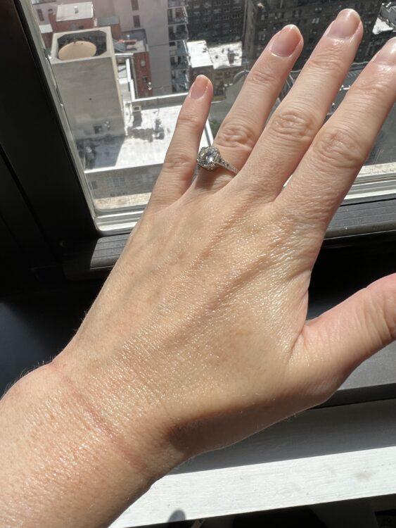 naturium sunscreen applied on the back of hand