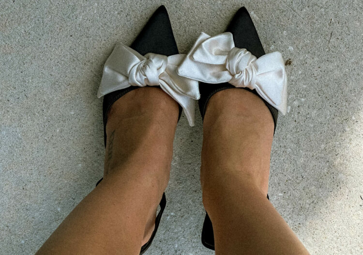 Black shoes with white bows on the toes