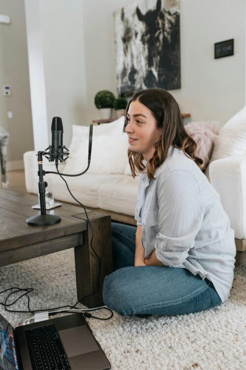 Person sitting on the floor while recording a podcast