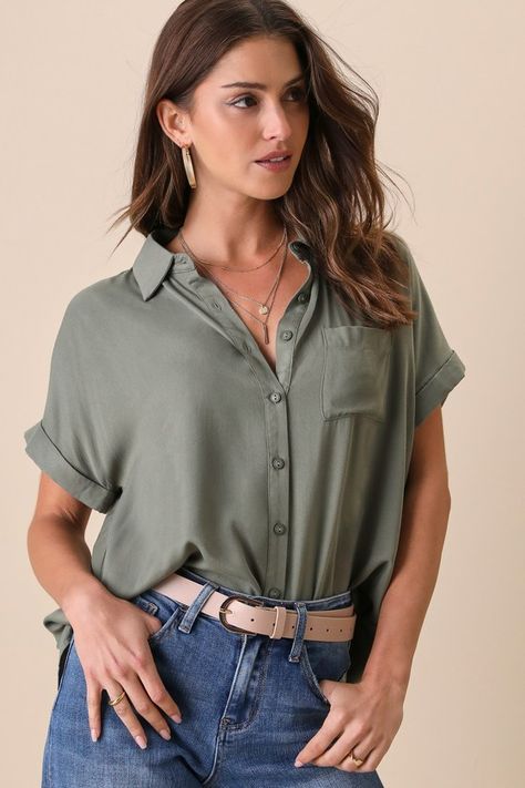 A model wears a green button up shirt with jeans, which is a great casual spring outfit idea