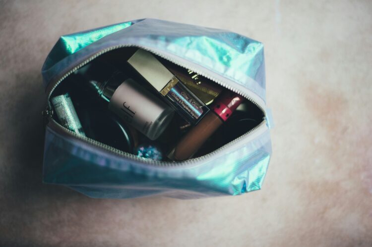 A bag containing the minimalist travel makeup picks to bring on vacation