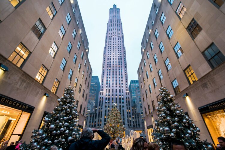 Christmas trees and people taking pictures at the Rockefeller Center