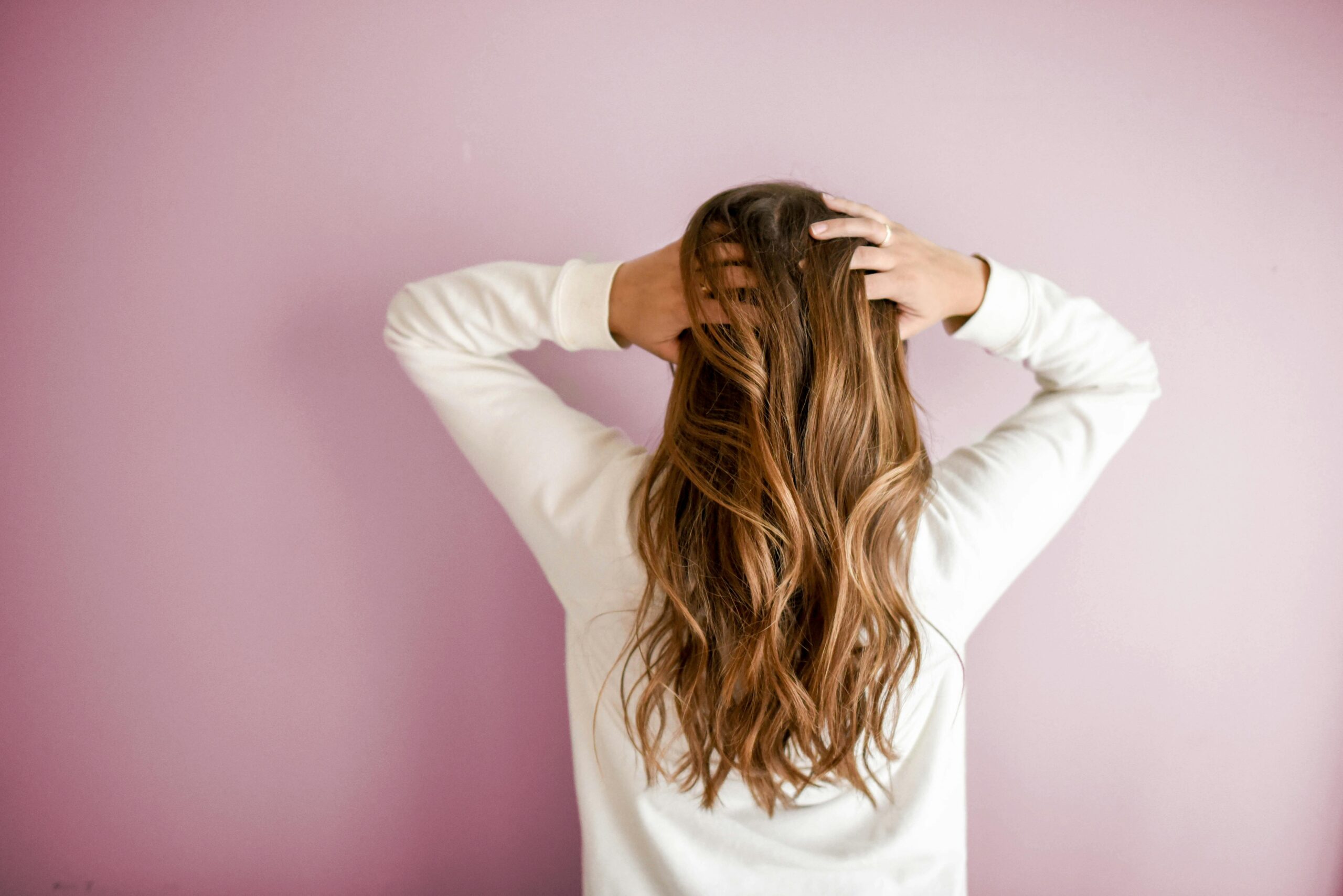 Person with a healthy hair routine shows off their long locks