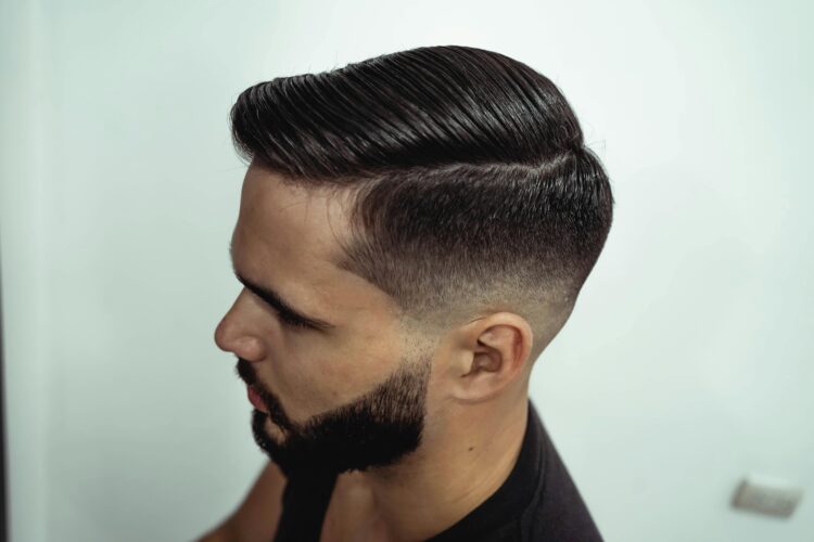 A shot of a person with a side-parted haircut, one of the best male medium-length haircuts