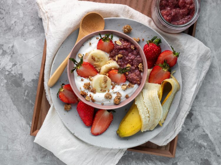 yogurt bowl with strawberries, bananas, and granola