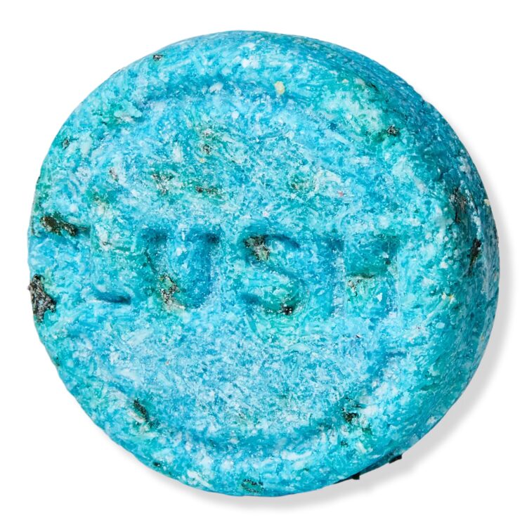 Product shot of teal and green-speckled Lush shampoo bar